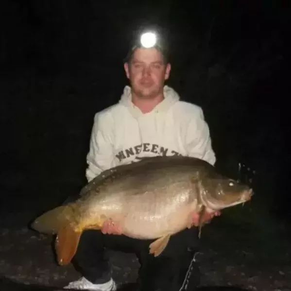 Shane with a mirror carp caught at night